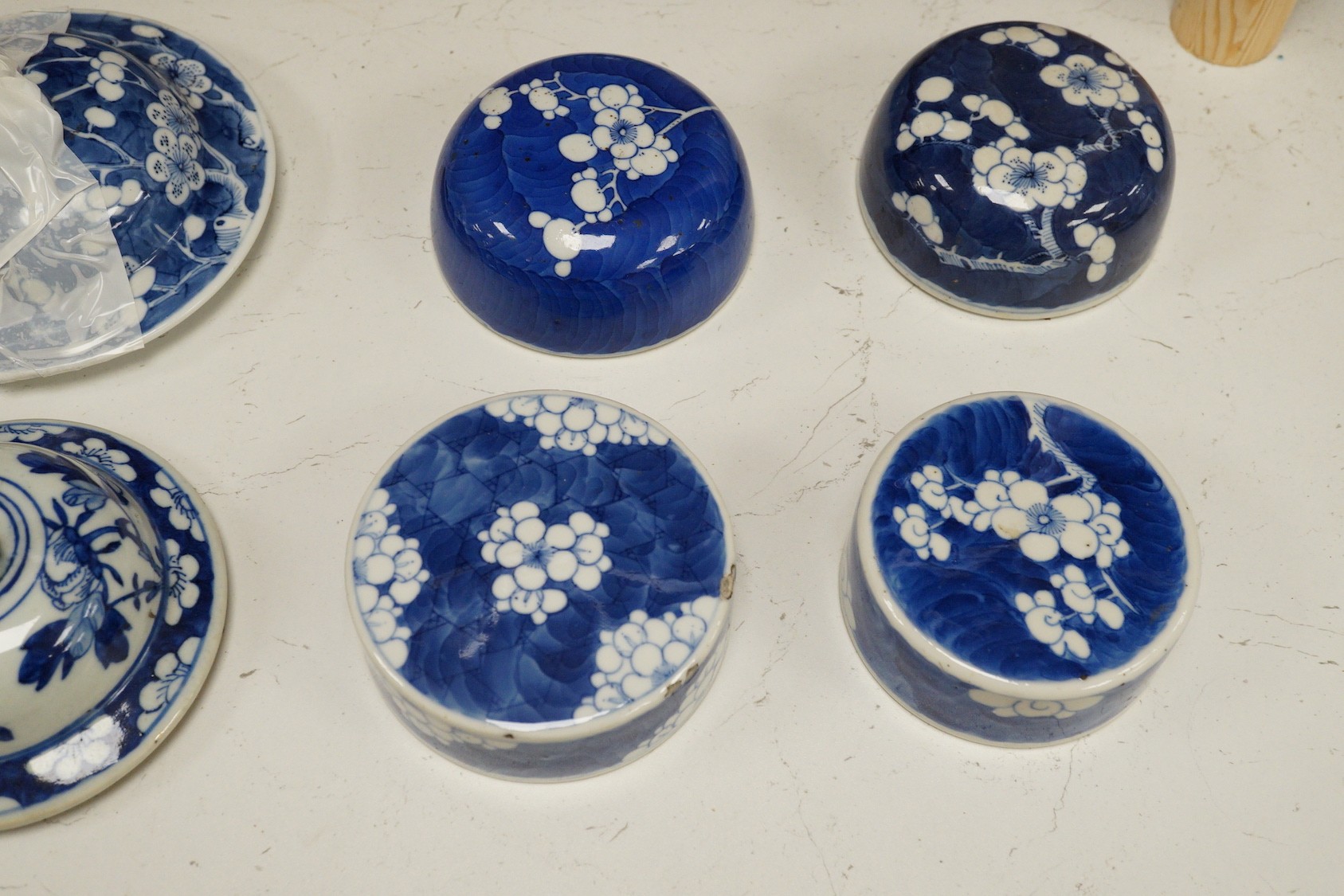 Twelve 18th/19th century Chinese blue and white ‘prunus’ vase and jar covers, largest 17 cm diameter, Provenance - D.C.Monk & Son, former dealers based in Kensington Church Street, London W8